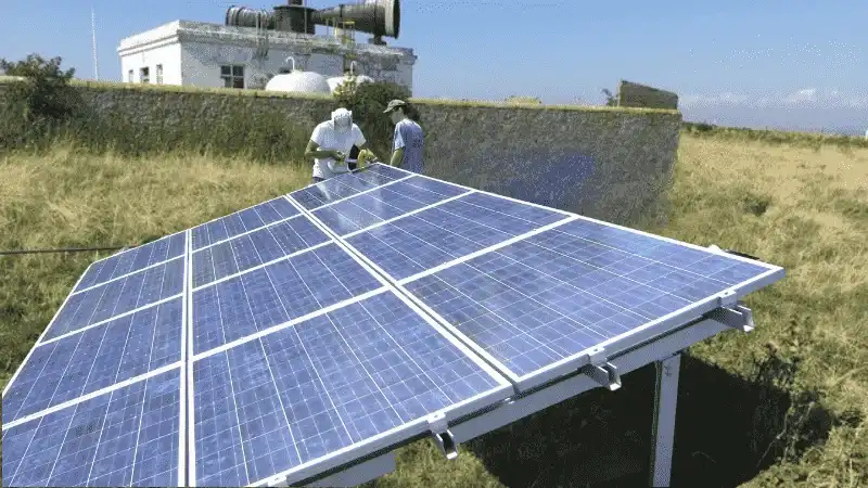 Two persons standing with Tilt Mount solar panel